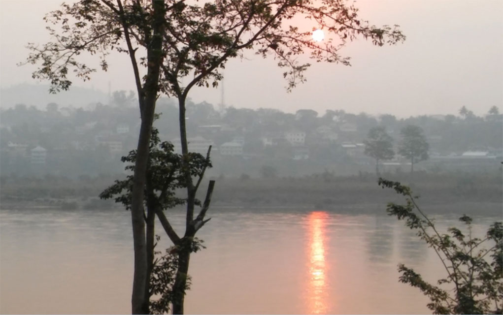 Top right: Dawn breaks hot and smoky on the Mekong River in Chiang Khong, Thailand, on April 11, 2016. Looking across the river to the neighboring Laos town of Huay Xai, the sun eases above the hills amidst intense haze and humidity. April is the hottest month in Thailand, and April 2016 was the hottest month in 65 years, breaking 100 degrees Fahrenheit every day the entire month. The dawn smoke is from slash-and-burn agriculture that is causing havoc on the forests on the Laos side of the border and throughout northern Thailand. 