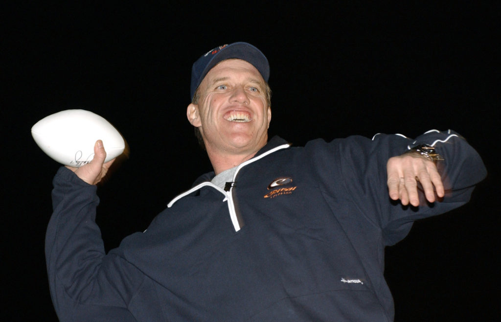 John Elway tosses footballs to the crowd during the Chairman's United Service Organizations Holiday Tour here Dec. 14. 