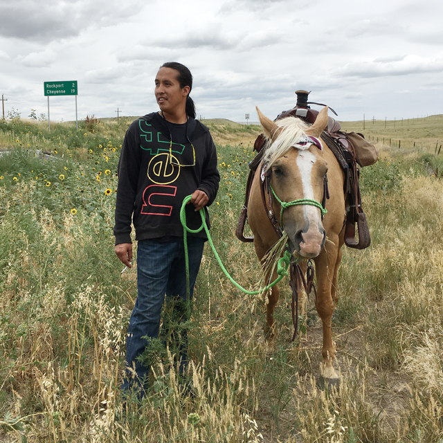 Despite some bad experiences with horses, Matt Bad Wound rides with the Tipi Raisers to share his Lakota culture with those outside the reservation, while raising funds to help build houses back home. 