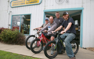 Louisville Cyclery employees, left to right, Mike Balog, Michael Hanna standing, Rusty Kreutzer and Matt Onorato