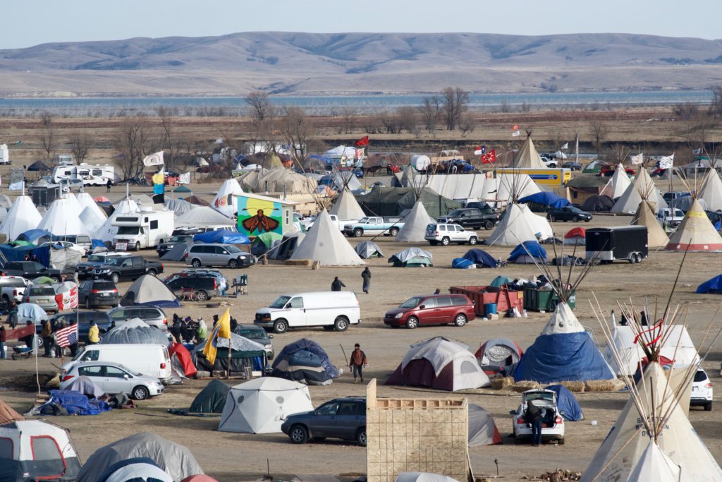 The 10,000 people on Standing Rock Sioux Reservation depend on the Missouri River — pictured here behind the main protest camp — for their water supply. 