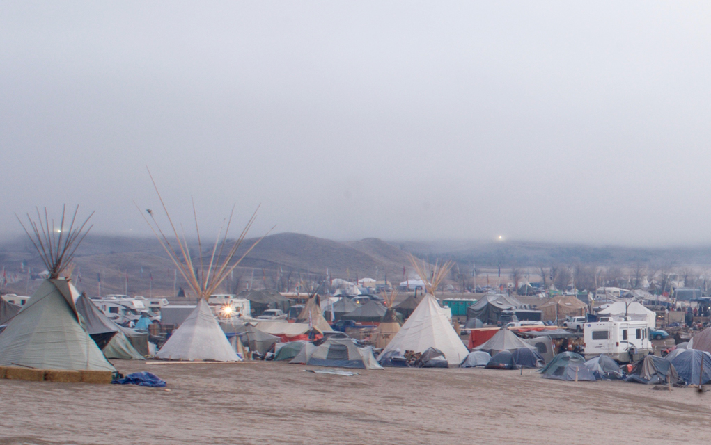 Dawn over the Oceto Sakowin protest camp. The banks of floodlights on the hills behind the camp have appeared in recent days and stay on throughout the night. They run along the path of the pipeline and create an eerie reminder of the ongoing struggle. 